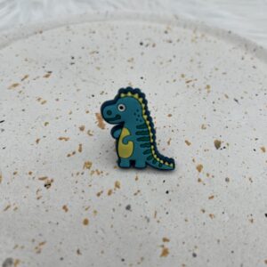 Bijou en silicone pour chaussure dinosaure turquoise et jaune