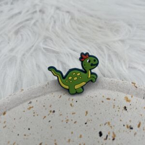 Bijou en silicone pour chaussure dinosaure vert et jaune